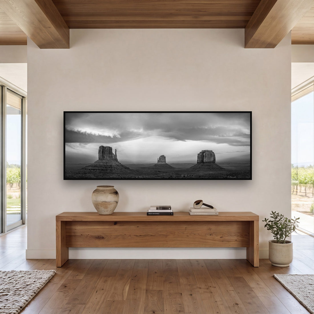 Large black and white fine art print of Monument Valley by Stephen Milner, shown in a styled interior