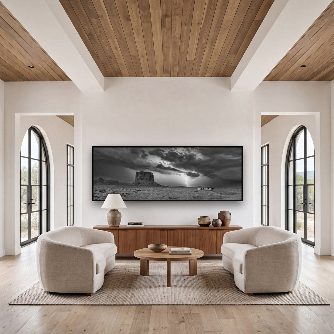 Large black and white fine art print of a dramatic mountain sky by Stephen Milner, shown in a styled interior