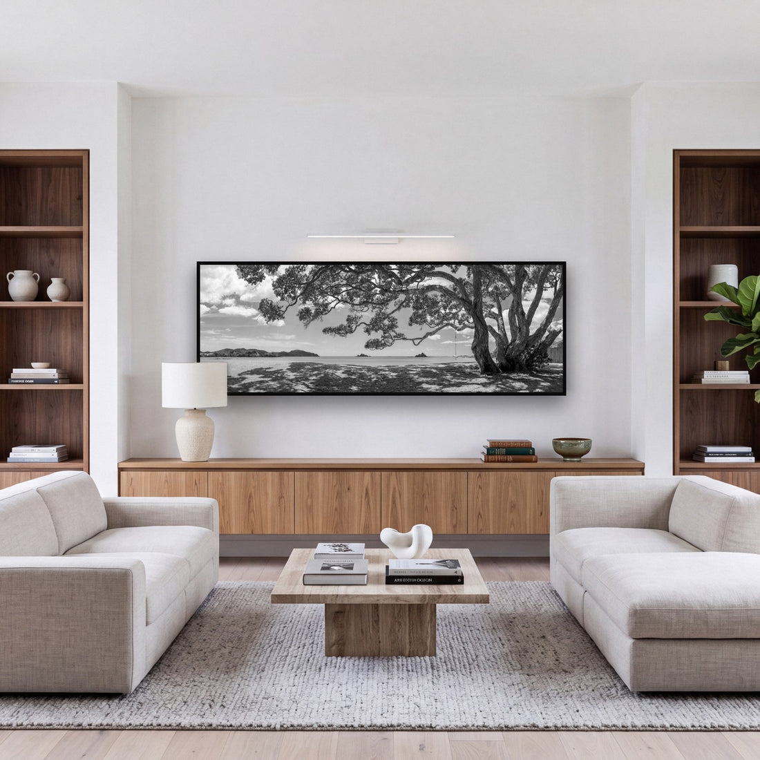 Large black and white fine art print of a New Zealand summer coastline by Stephen Milner, shown in a styled interior