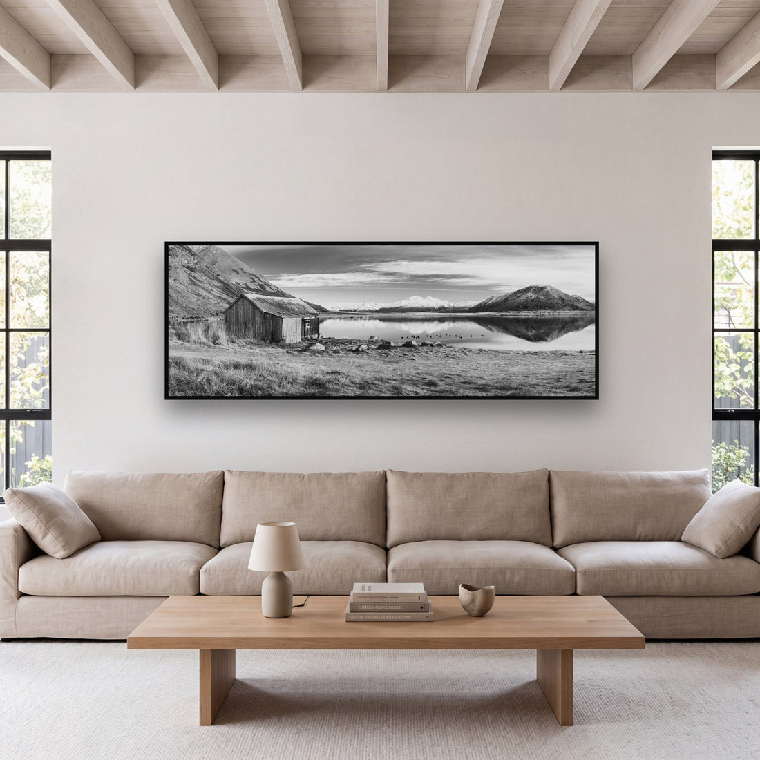 Large black and white fine art print of a New Zealand high country landscape by Stephen Milner, shown in a styled interior