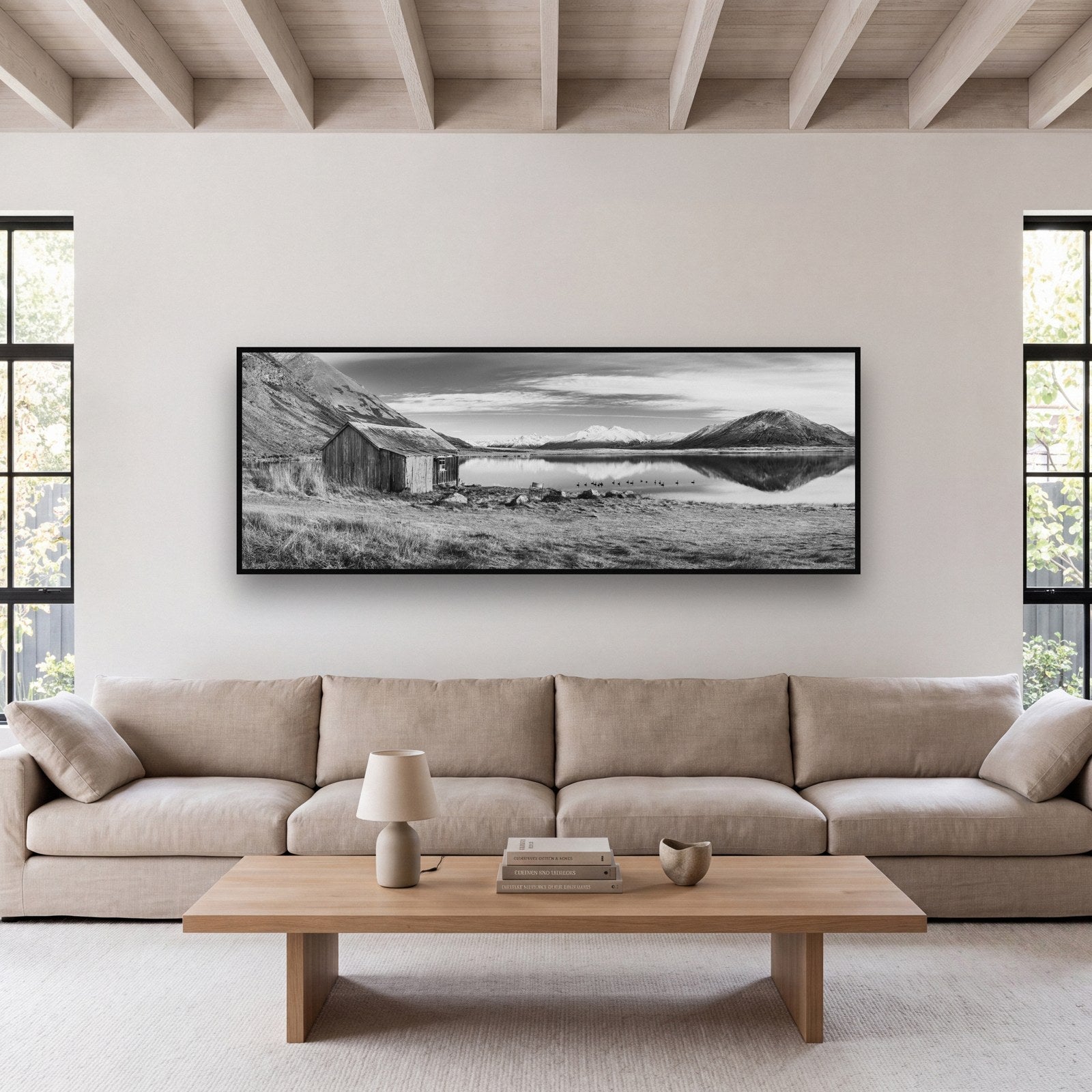 Large black and white fine art print of a New Zealand high country landscape by Stephen Milner, shown in a styled interior