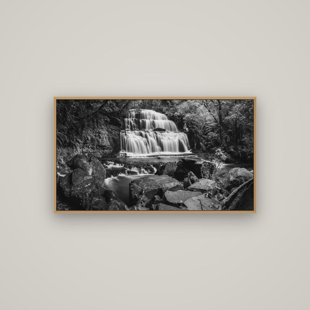 Elysian Serenity, Purakaunui Falls, Basel Natural Oak, 107×60 cm. New Zealand fine art photograph under matte acrylic glass.