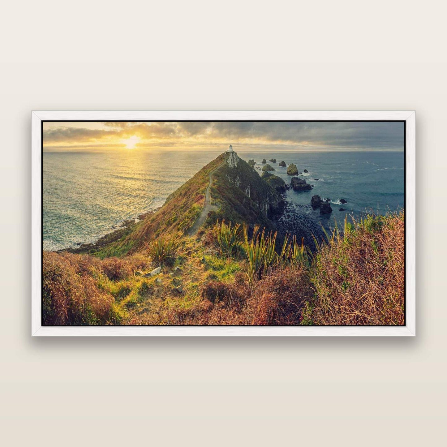 Guiding Light, Nugget Point Sunrise — framed metallic canvas print, White frame. New Zealand fine art landscape wall art by Stephen Milner.