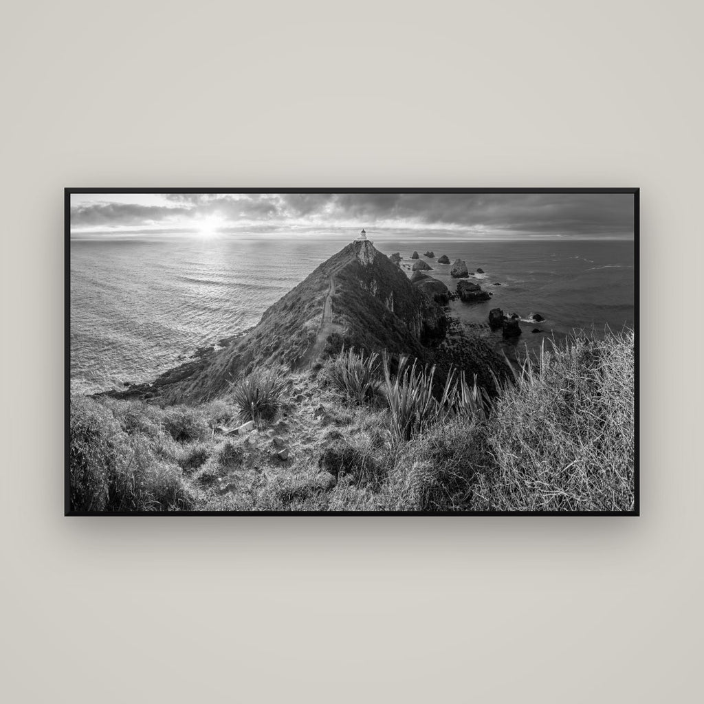 Guiding Light, Nugget Point Sunrise — Basel Black Matte, 160×90 cm. New Zealand fine art wall art by Stephen Milner.