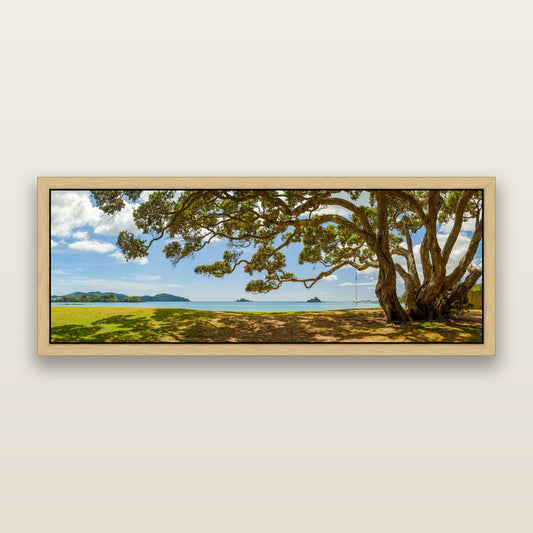 Harbour of Summer Light, Pōhutukawa Bloom, Bay of Islands — framed metallic canvas print, Natural frame. New Zealand fine art landscape wall art by Stephen Milner.