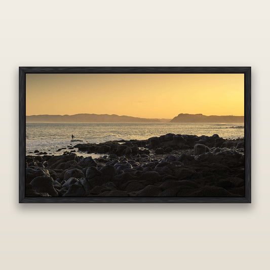 Surfing the Sunrise, Raglan — framed metallic canvas print, Black frame. New Zealand fine art landscape wall art by Stephen Milner.