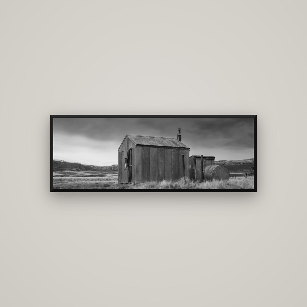 Whispers of Solitude, The Iron Hut — Basel Black Matte, 113×40 cm. New Zealand fine art wall art by Stephen Milner.