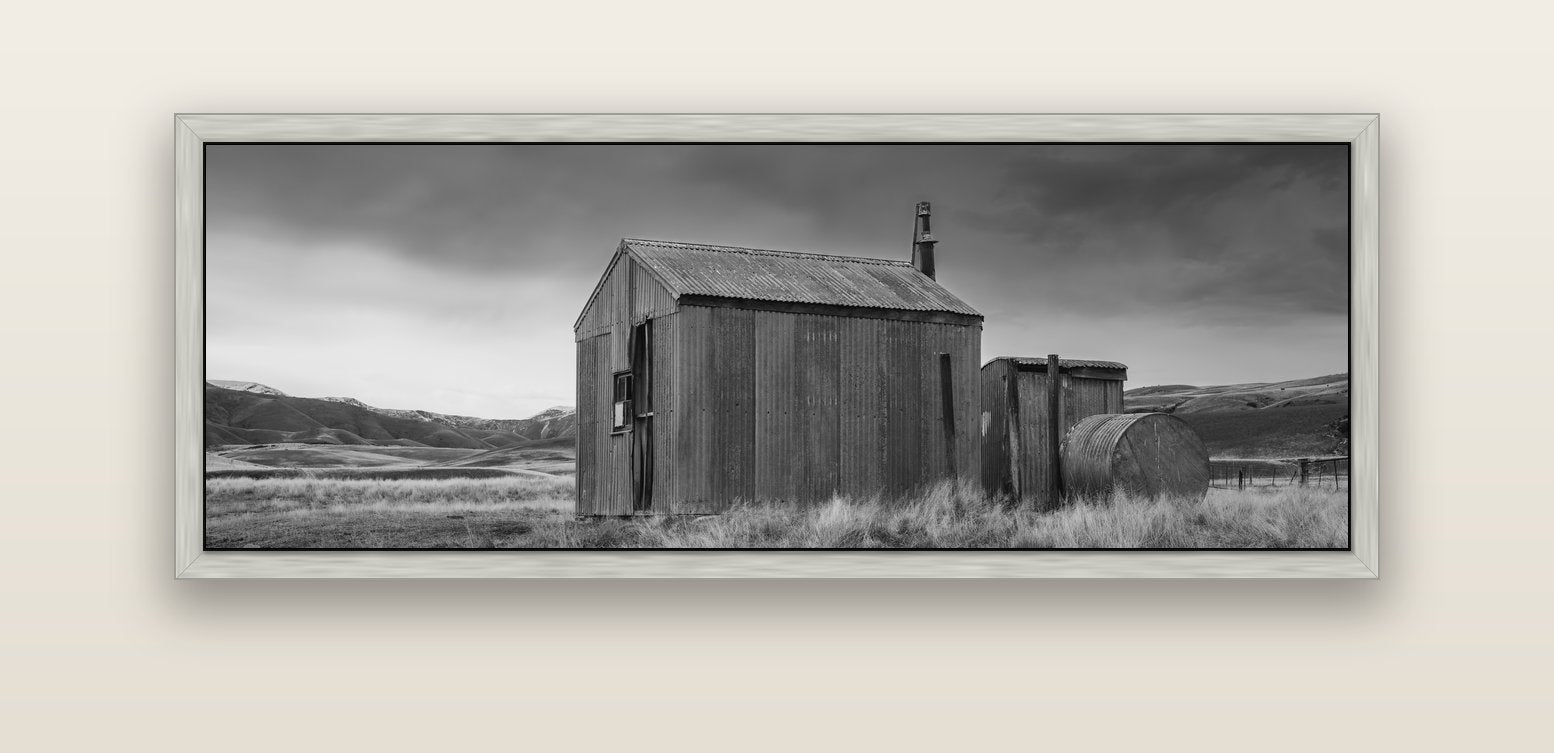 Whispers of Solitude, The Iron Hut — silver float frame canvas, 152 × 56 cm. New Zealand fine art landscape wall art by Stephen Milner.