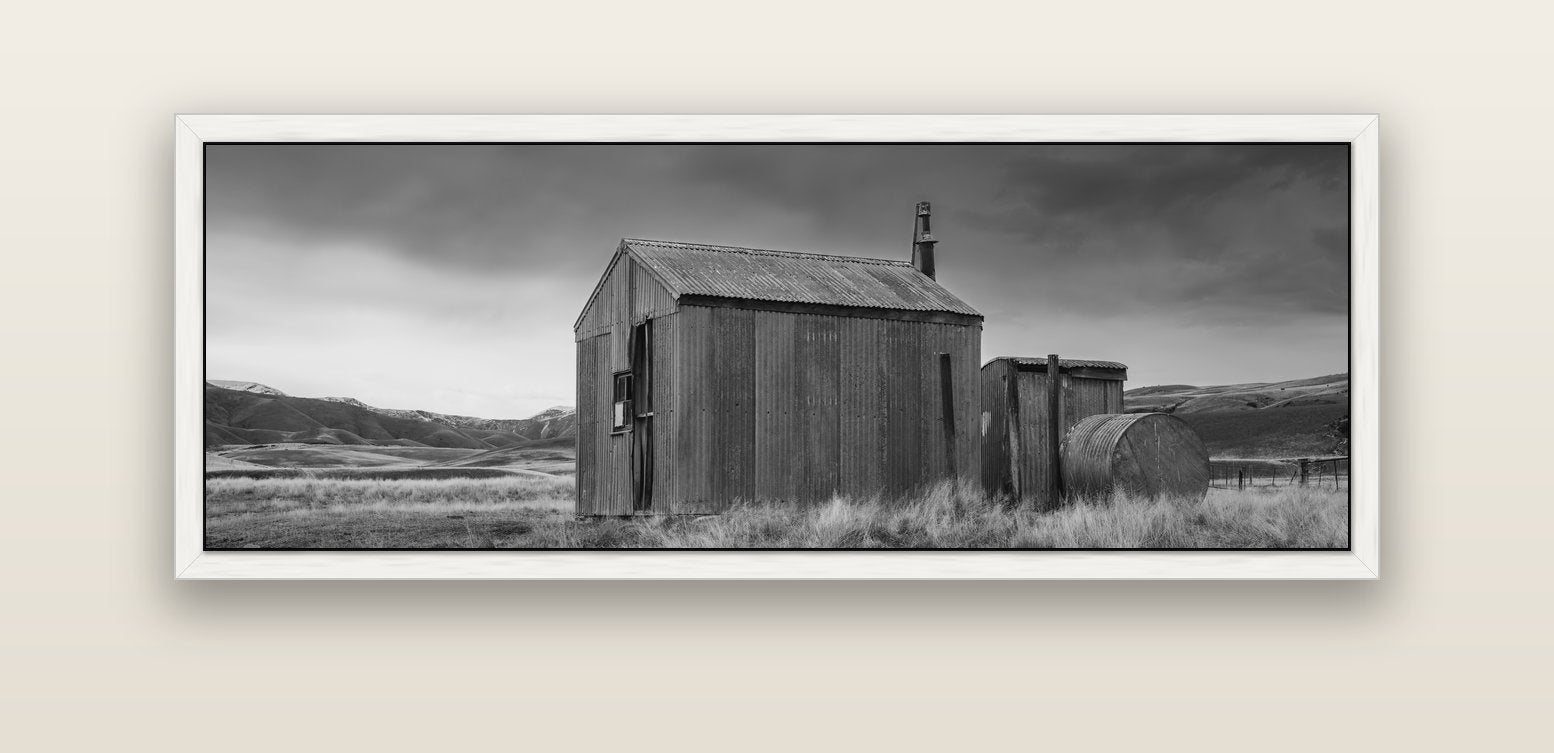 Whispers of Solitude, The Iron Hut — white float frame canvas, 152 × 56 cm. New Zealand fine art landscape wall art by Stephen Milner.