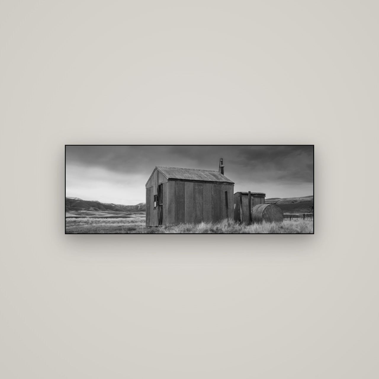 Whispers of Solitude, The Iron Hut — Slimline Black, 113×40 cm. New Zealand fine art wall art by Stephen Milner.
