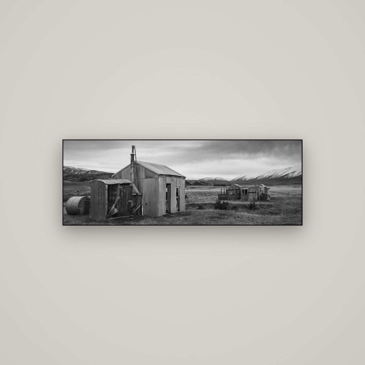 Whispers of Solitude, The Station Huts — Slimline Black, 113×40 cm. New Zealand fine art wall art by Stephen Milner.